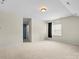 Expansive bonus room with neutral carpeting, a window, and adjoining door to other rooms at 8712 Soaring Eagle Ln, Waxhaw, NC 28173