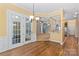Dining area with hardwood floors, chandelier, and open access to the kitchen and living spaces at 8712 Soaring Eagle Ln, Waxhaw, NC 28173