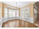 Bright dining room with hardwood floors, bay window, glass doors, and elegant chandelier at 8712 Soaring Eagle Ln, Waxhaw, NC 28173