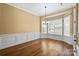 Spacious dining room with hardwood floors, elegant lighting, and classic chair rail molding at 8712 Soaring Eagle Ln, Waxhaw, NC 28173