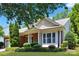 Close-up of a well-maintained home with brick accents, columns, and manicured bushes at 8712 Soaring Eagle Ln, Waxhaw, NC 28173