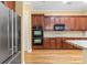 Modern kitchen featuring stainless steel appliances, granite countertops, and wood floors at 8712 Soaring Eagle Ln, Waxhaw, NC 28173