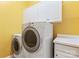 Bright laundry room equipped with a washer, dryer, upper cabinets, and countertop space at 8712 Soaring Eagle Ln, Waxhaw, NC 28173