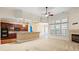 Spacious living room featuring a fireplace, large windows, and seamless flow into the kitchen at 8712 Soaring Eagle Ln, Waxhaw, NC 28173