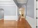 Spacious living room showcasing hardwood floors, wainscoting, archway, and natural light at 8712 Soaring Eagle Ln, Waxhaw, NC 28173