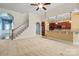 Open-concept living room features a view of the kitchen, hardwood stairs and arched doorway at 8712 Soaring Eagle Ln, Waxhaw, NC 28173