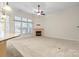 Spacious living room showcasing fireplace, abundant natural light, and neutral decor at 8712 Soaring Eagle Ln, Waxhaw, NC 28173