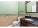 Chic powder room with decorative tile, granite countertop, and classic fixtures at 8712 Soaring Eagle Ln, Waxhaw, NC 28173