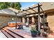 Stunning backyard patio with a hot tub, pergola, string lights, and cozy seating area perfect for outdoor gatherings at 107 Creekwood Dr, Dallas, NC 28034