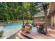 Inviting backyard patio with a pool, pergola, hot tub, and outdoor seating for relaxing and entertaining at 107 Creekwood Dr, Dallas, NC 28034