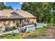 Beautiful backyard featuring a sparkling pool, hot tub, and outdoor seating area at 107 Creekwood Dr, Dallas, NC 28034