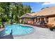 Enjoy this backyard's hot tub, pergola-covered deck, and sparkling pool with plenty of seating at 107 Creekwood Dr, Dallas, NC 28034