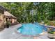The backyard boasts a luxurious pool with a decorative waterfall and nearby seating at 107 Creekwood Dr, Dallas, NC 28034