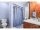 Bathroom with blue walls and a shower/tub combo with blue shower curtain at 107 Creekwood Dr, Dallas, NC 28034