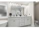 Bright bathroom featuring a double vanity with white cabinetry and a large mirror at 107 Creekwood Dr, Dallas, NC 28034