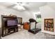 Bonus room with a TV, treadmill, and bright overhead lighting at 107 Creekwood Dr, Dallas, NC 28034