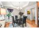Cozy dining area features a glass-top table, leather chairs, and elegant chandelier lighting fixture at 107 Creekwood Dr, Dallas, NC 28034