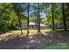 Charming single-story brick home surrounded by lush trees and a well-manicured lawn at 107 Creekwood Dr, Dallas, NC 28034