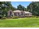 Beautiful brick home with manicured lawn and mature trees, offering curb appeal at 107 Creekwood Dr, Dallas, NC 28034