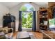 Bright living room featuring a large window with backyard views and hardwood floors at 107 Creekwood Dr, Dallas, NC 28034