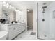 Bright main bathroom boasts double sink vanity, stand alone tub and large glass shower enclosure at 107 Creekwood Dr, Dallas, NC 28034
