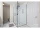 Modern shower with glass enclosure, rainfall shower head, and white tiled walls at 107 Creekwood Dr, Dallas, NC 28034