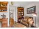 Cozy sitting area with comfortable leather chair, bookshelf, and hardwood flooring at 107 Creekwood Dr, Dallas, NC 28034