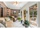 Inviting sunroom with brick accent wall, tile floors, and plenty of natural light at 107 Creekwood Dr, Dallas, NC 28034