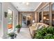 Bright sunroom with brick accent wall, tile floors, indoor hot tub and access to outdoors at 107 Creekwood Dr, Dallas, NC 28034