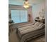 Bedroom with a ceiling fan, decorative wall art and large window allowing natural light at 10825 Traders Ct, Davidson, NC 28036