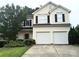 Charming two-story home with a two-car garage and well-maintained front yard with mature landscaping at 10825 Traders Ct, Davidson, NC 28036