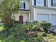 Charming home with lush landscaping and vibrant flowers that add curb appeal and welcome at 10825 Traders Ct, Davidson, NC 28036