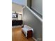 Hallway with hardwood floors, staircase, and a bench with access to the living room at 10825 Traders Ct, Davidson, NC 28036
