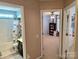 Hallway with views of a bathroom and bedroom with ceiling fan and carpeting at 10825 Traders Ct, Davidson, NC 28036