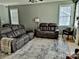 Comfortable living room with dual sofas, a ceiling fan, and natural light from the windows at 10825 Traders Ct, Davidson, NC 28036