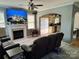 Living room featuring a fireplace, mounted TV, and open floor plan leading into kitchen at 10825 Traders Ct, Davidson, NC 28036