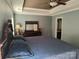 Spacious main bedroom featuring a tray ceiling, fan, and ensuite bathroom at 10825 Traders Ct, Davidson, NC 28036