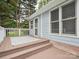 Side angle view of a home's deck, complete with an outdoor rug and well-kept facade at 1109 Manchester Ln, Charlotte, NC 28227