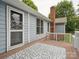 Charming back deck with a patterned rug, leading to a well-maintained backyard at 1109 Manchester Ln, Charlotte, NC 28227