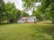Well maintained backyard with lush grass and established trees at 1109 Manchester Ln, Charlotte, NC 28227