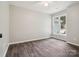 Bedroom featuring wood-look floors, neutral walls, a ceiling fan, and a window at 1109 Manchester Ln, Charlotte, NC 28227