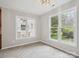 Bright dining area with large windows overlooking the green backyard and gray flooring at 1109 Manchester Ln, Charlotte, NC 28227