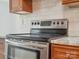 Close-up of the stainless steel oven range with tile backsplash and granite countertops at 1109 Manchester Ln, Charlotte, NC 28227