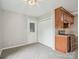 Bright kitchen area features wood cabinets, gray-toned floors, and white pantry doors at 1109 Manchester Ln, Charlotte, NC 28227