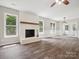 This living room features a painted brick fireplace and durable vinyl flooring at 1109 Manchester Ln, Charlotte, NC 28227