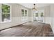 Open floorplan living room with chair railing, wood-look floors, and a glass door to the outside at 1109 Manchester Ln, Charlotte, NC 28227