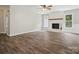 Spacious living room features a brick fireplace with wood mantle, vinyl flooring, and natural light at 1109 Manchester Ln, Charlotte, NC 28227