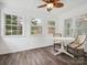 Bright sunroom features wood-look floors, wainscotting, and three windows offering natural light at 1109 Manchester Ln, Charlotte, NC 28227