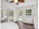 Bright sunroom with wood-look floors features a door and sliding glass doors to another room at 1109 Manchester Ln, Charlotte, NC 28227