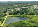 Aerial view of a pond reflecting the sky, surrounded by trees and houses in a residential area at 132 General Pemberton St, Stanley, NC 28164